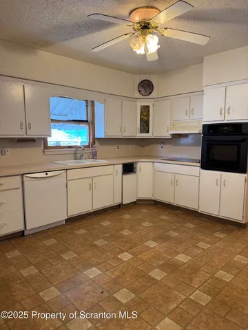 a kitchen with stainless steel appliances granite countertop a sink and cabinets