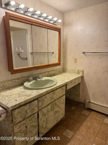 a bathroom with a sink and a mirror