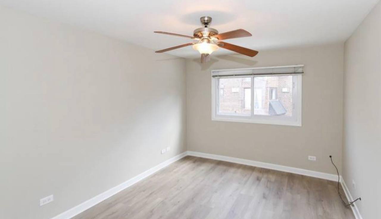 677 South River Road, Unit 2H Des Plaines, IL 60016 - Photo 9 of 15 a view of an empty room with a window