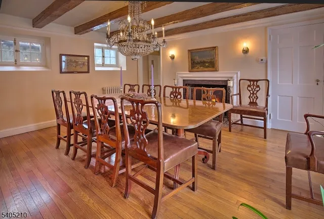 a view of a dining room with furniture wooden floor and chandelier