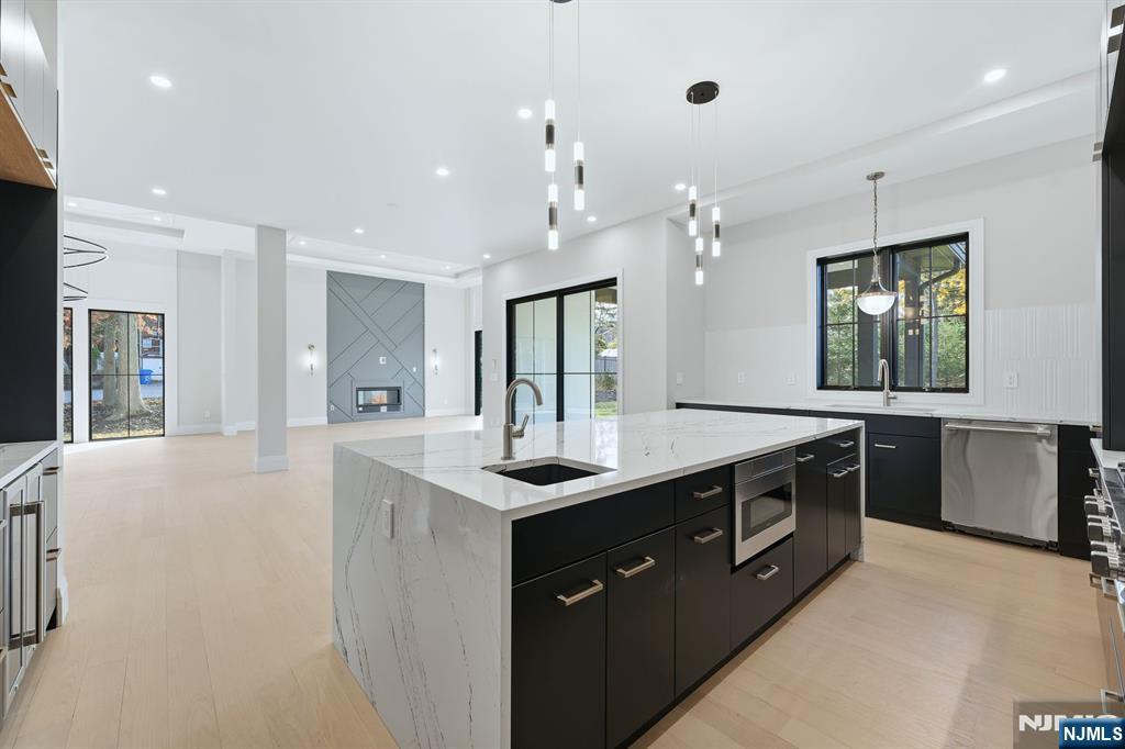 121 Engle Street Cresskill, NJ 07626 - Photo 16 of 50 a large kitchen with a sink and dishwasher a stove top oven with wooden floor