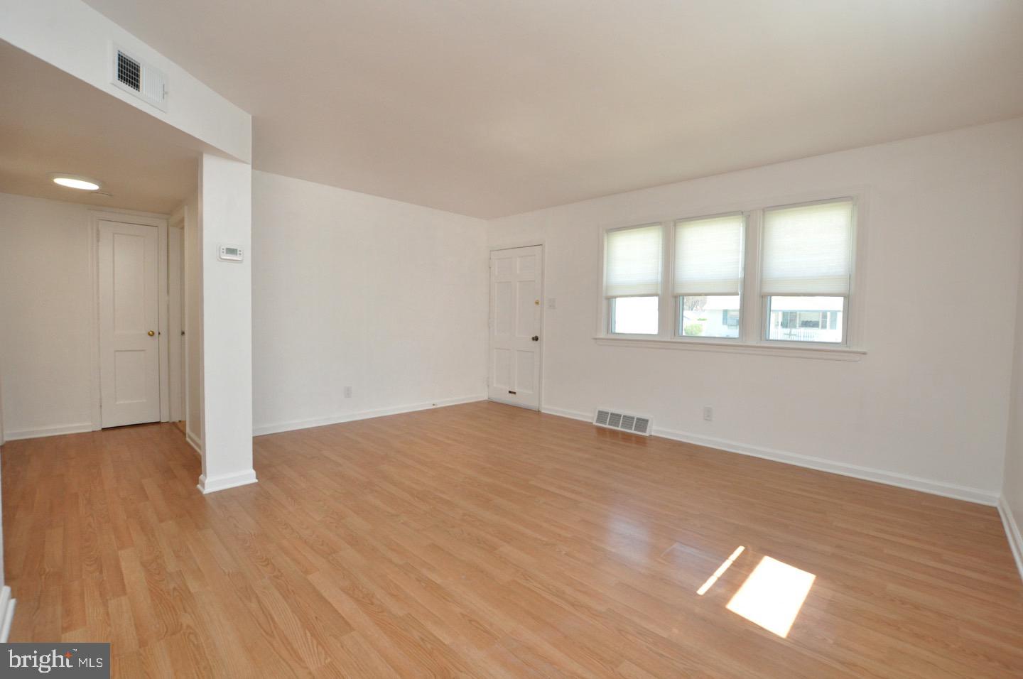 432 North Coles Avenue Maple Shade, NJ 08052 - Photo 4 of 26 an empty room with wooden floor and windows