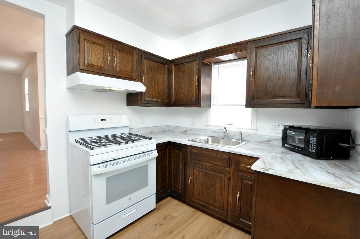 432 North Coles Avenue Maple Shade, NJ 08052 - Photo 10 of 26 a kitchen with stainless steel appliances a stove a sink and a microwave
