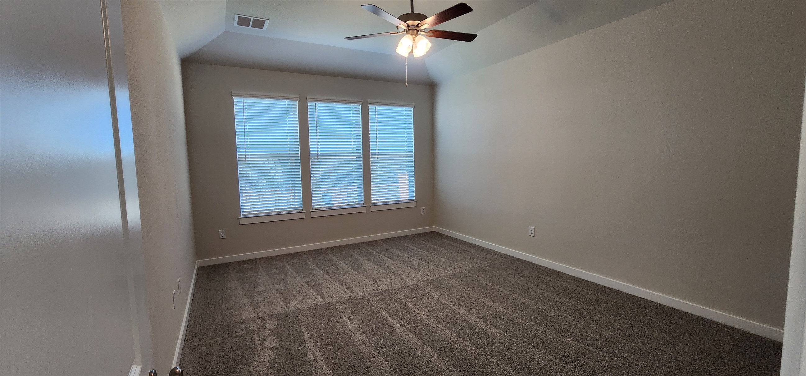 2248 Delano Drive Leander, TX 78641 - Photo 9 of 33 Empty room featuring carpet flooring, ceiling fan, and lofted ceiling