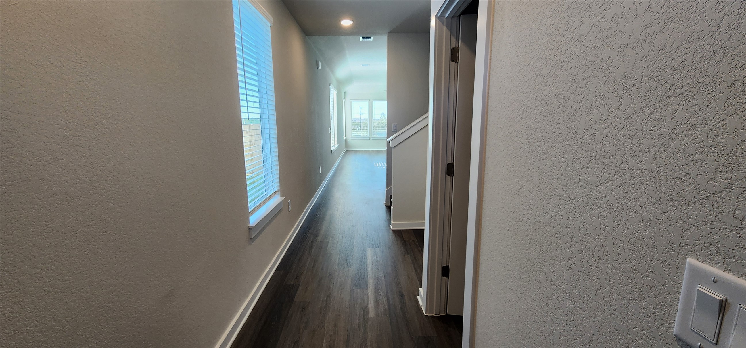 2248 Delano Drive Leander, TX 78641 - Photo 2 of 33 Hall with a textured wall, dark wood-style flooring, and recessed lighting