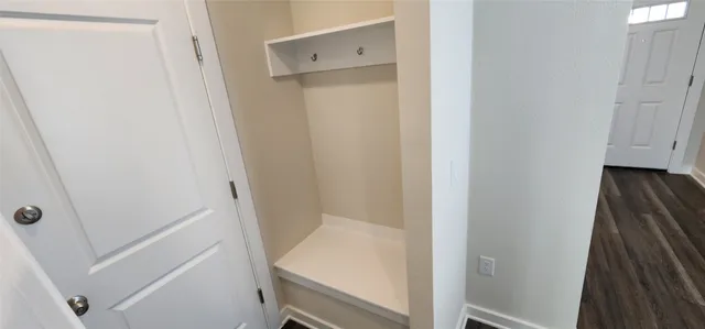 a kitchen with a sink a refrigerator and wooden floor