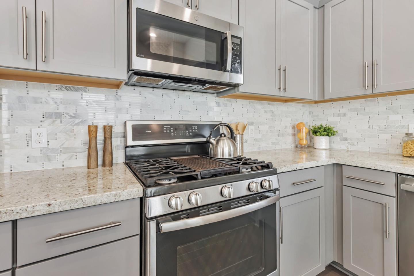 390 Riesling Avenue, Unit 30 Milpitas, CA 95035 - Photo 11 of 37 a kitchen with granite countertop white cabinets stainless steel appliances and a sink
