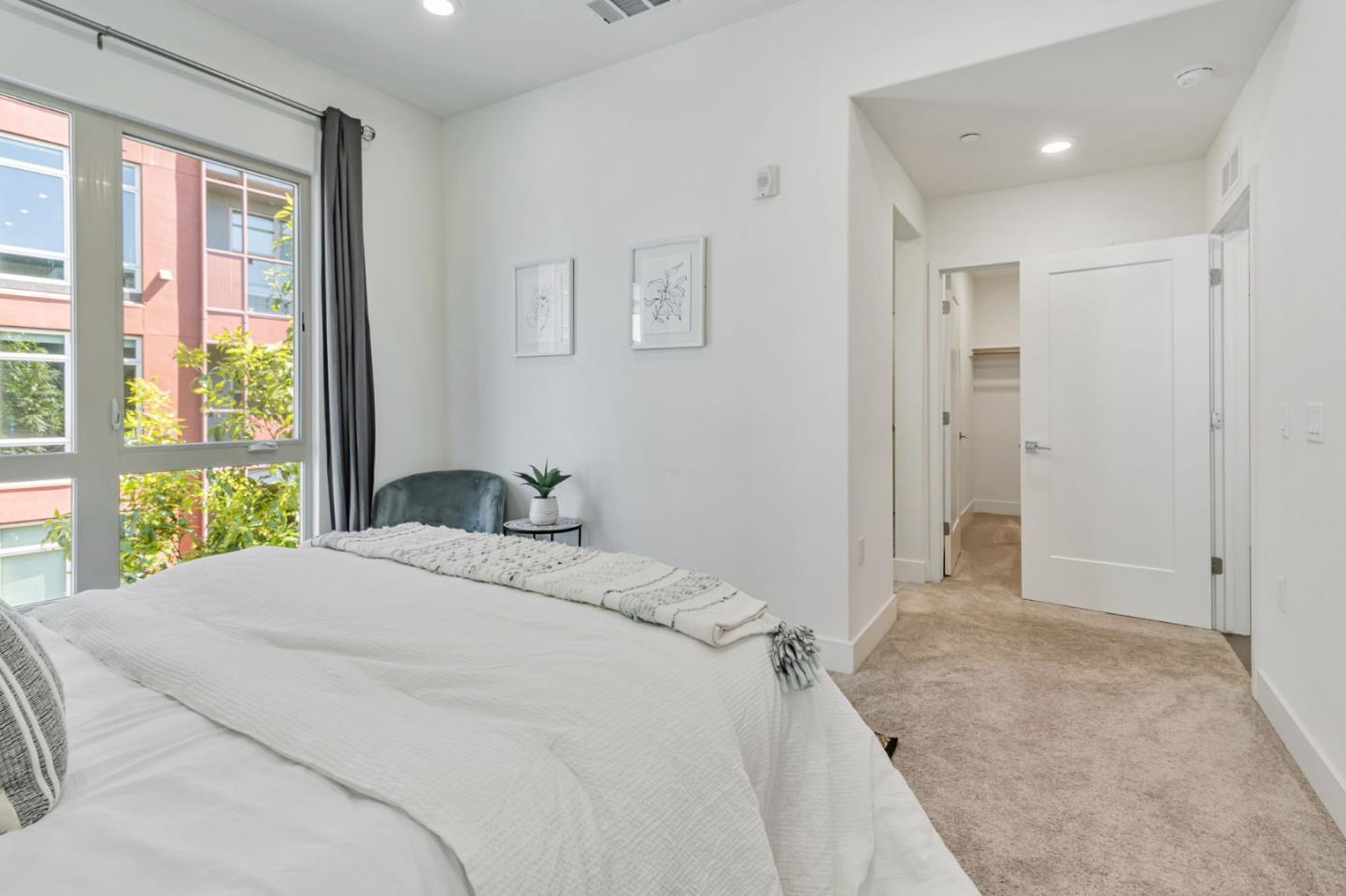 390 Riesling Avenue, Unit 30 Milpitas, CA 95035 - Photo 22 of 37 a bedroom with a bed and a large window