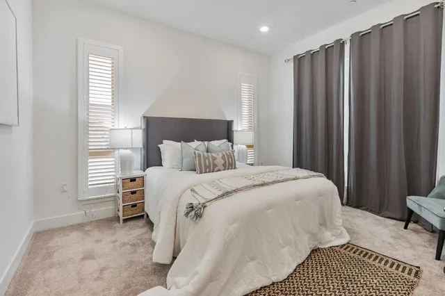 a bedroom with a bed and a mirror