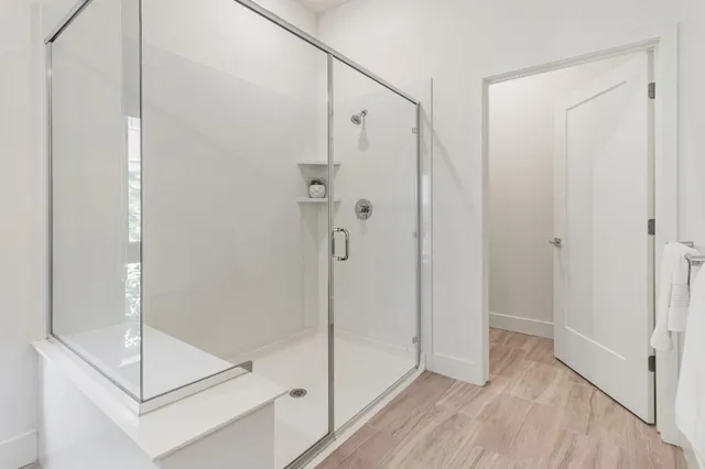 a bathroom with a sink toilet vanity and shower