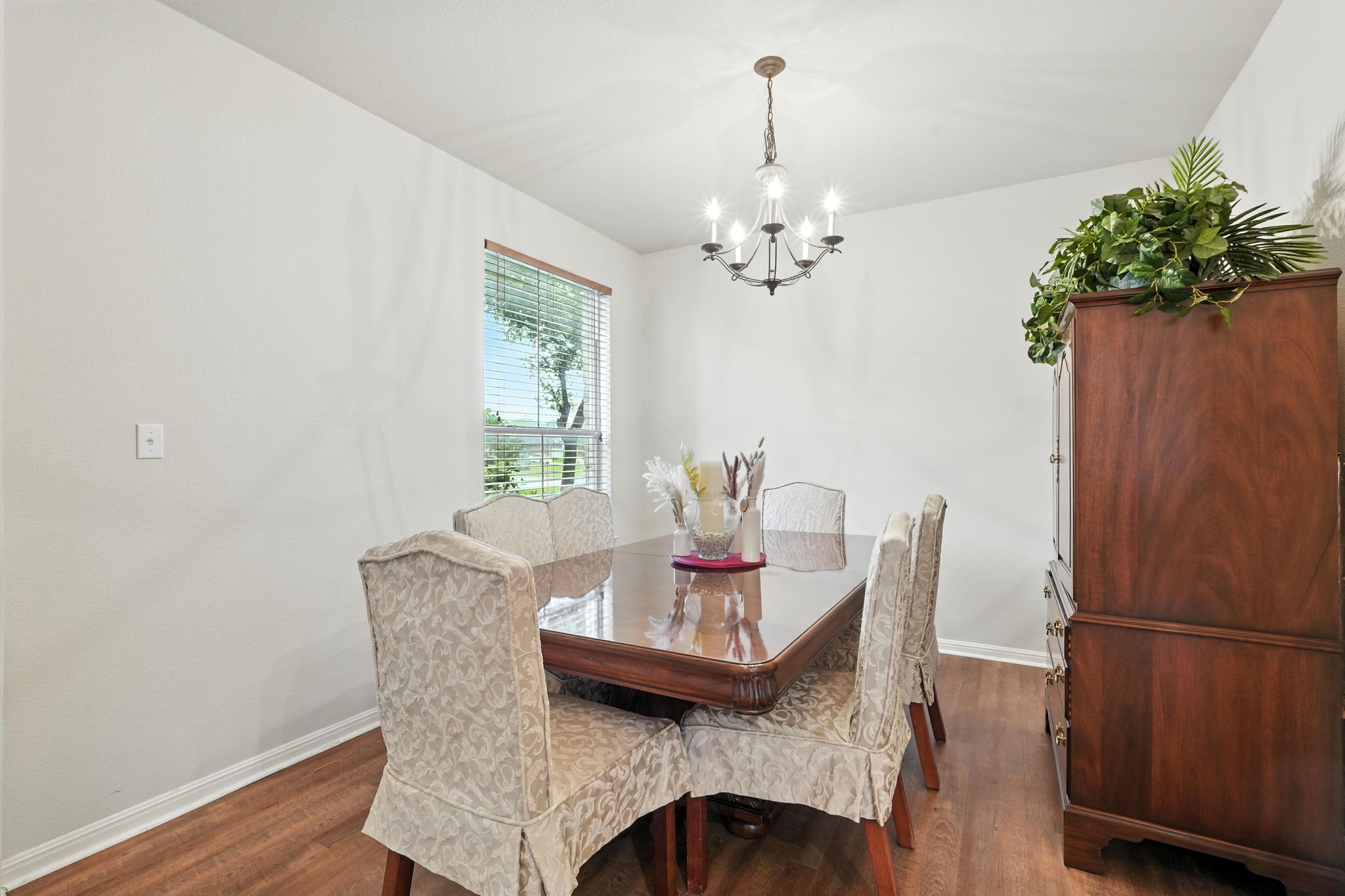 1802 Misty Ridge Leander, TX 78641 - Photo 8 of 39 Dining room with a chandelier and dark wood-style floors