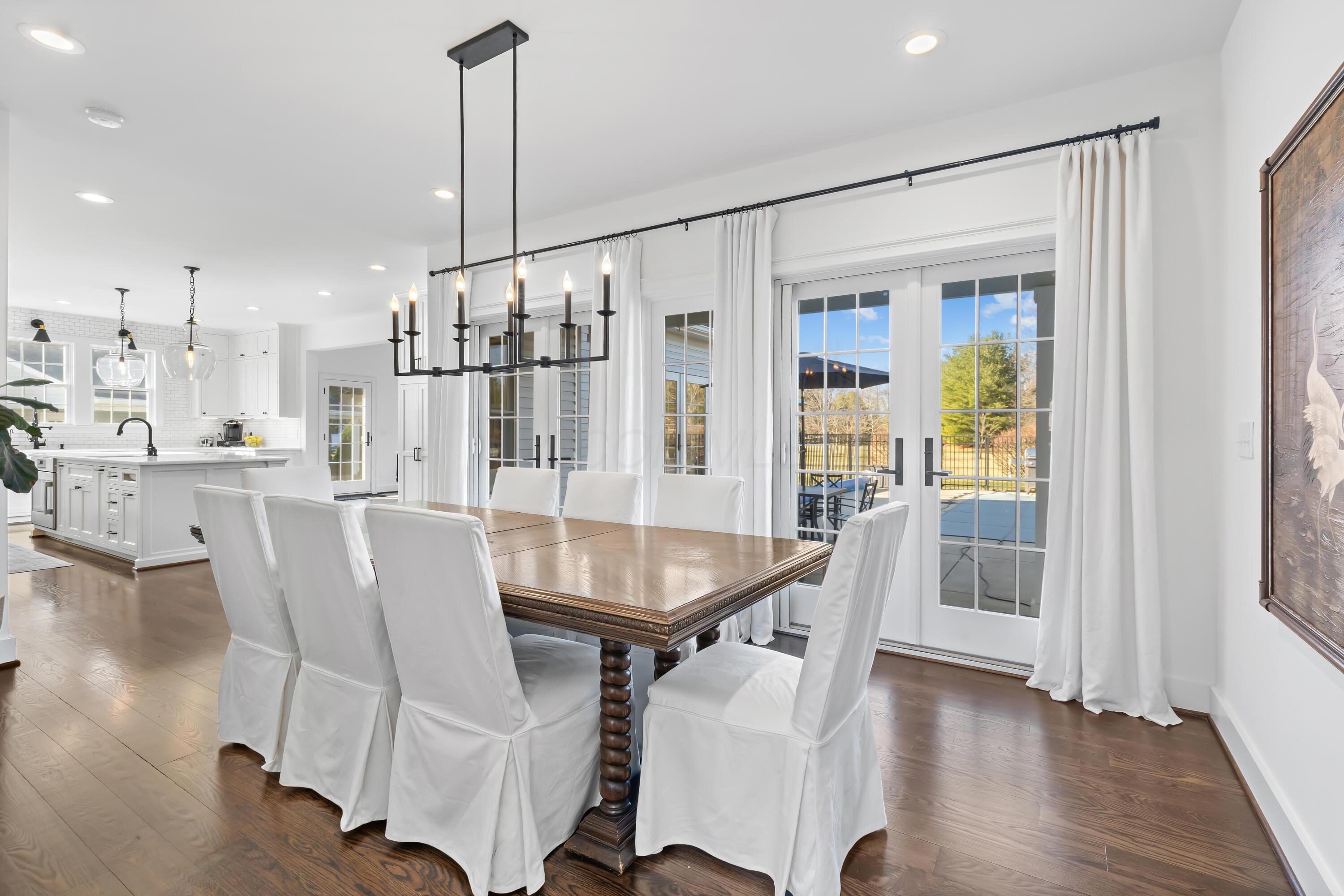 1364 Dale Ford Road Delaware, OH 43015 - Photo 22 of 112 • Hardwood flooring • White painted walls • Chandelier • Can lighting • (2) sets of french doors to covered patio