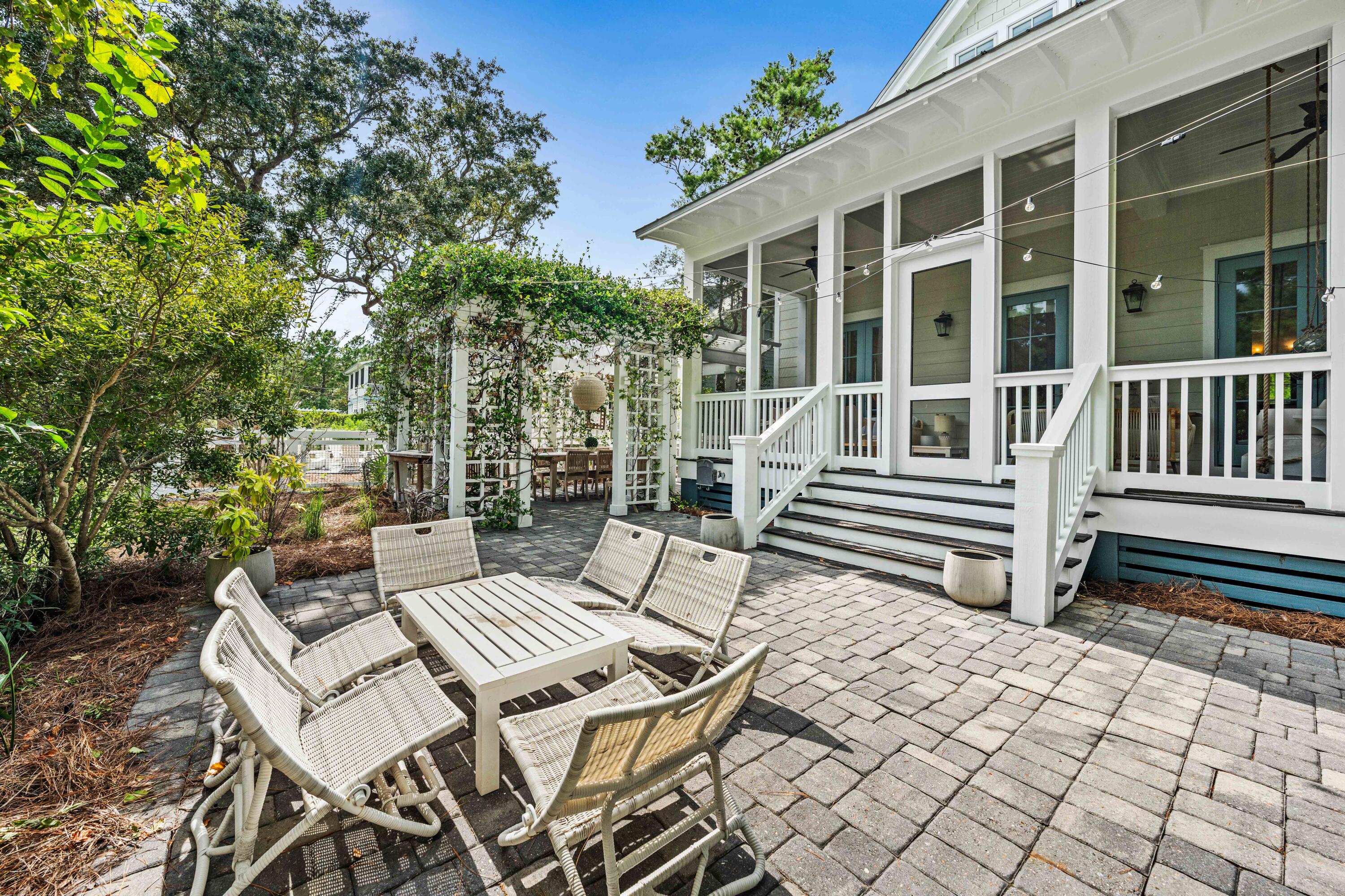 406 Red Cedar Way Santa Rosa Beach, FL 32459 - Photo 13 of 60 a view of a patio with a chairs and table in a patio
