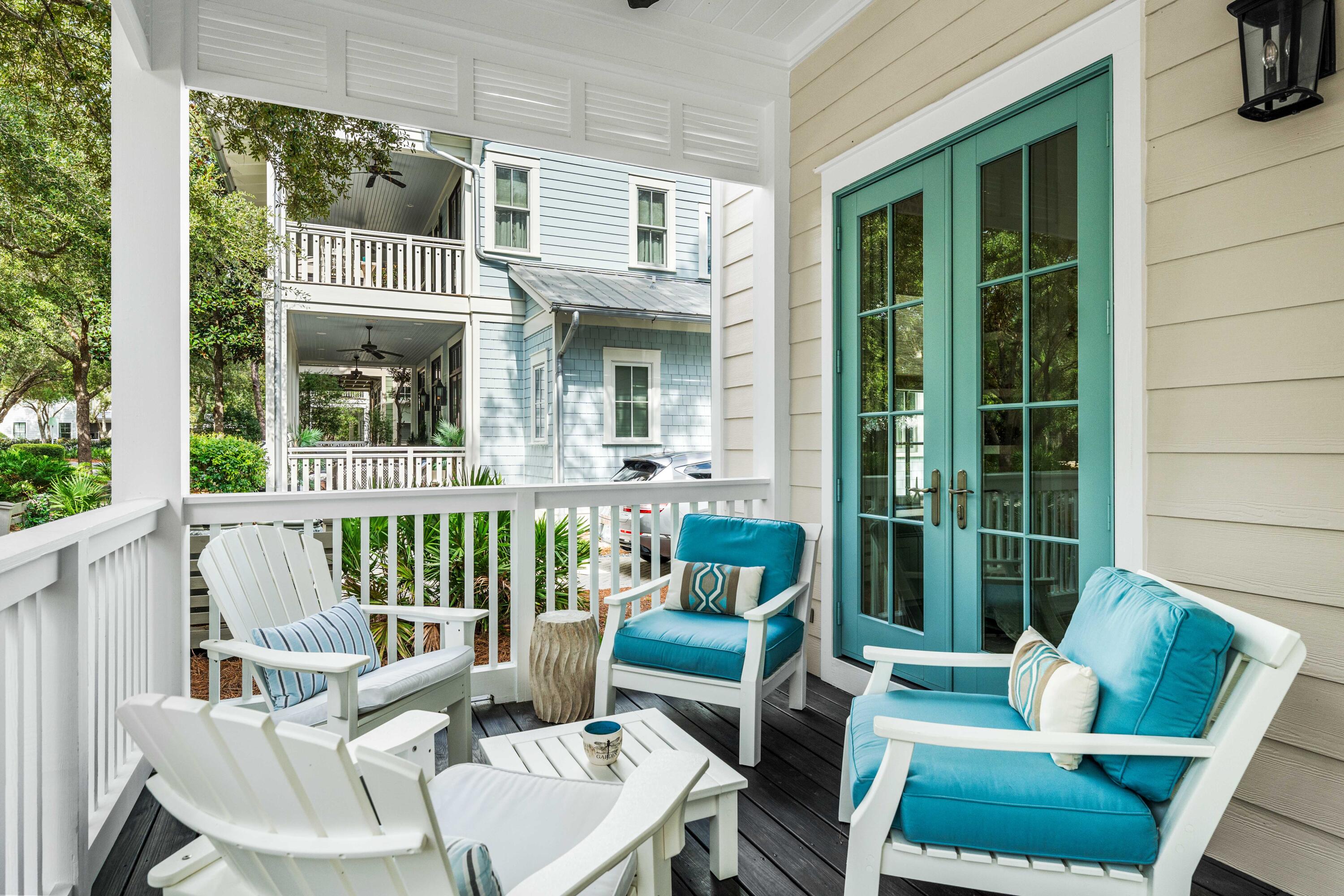 406 Red Cedar Way Santa Rosa Beach, FL 32459 - Photo 24 of 60 a view of a patio with couches chairs potted plants and floor to ceiling window