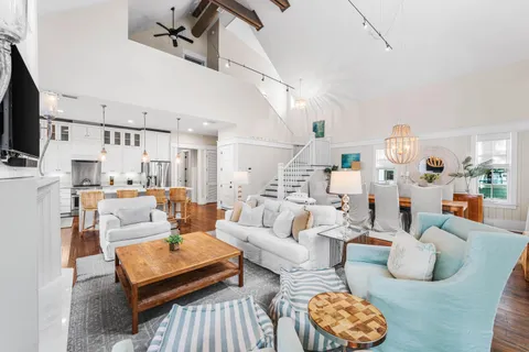 a kitchen with stainless steel appliances granite countertop a stove a sink dishwasher and a microwave oven with white cabinets