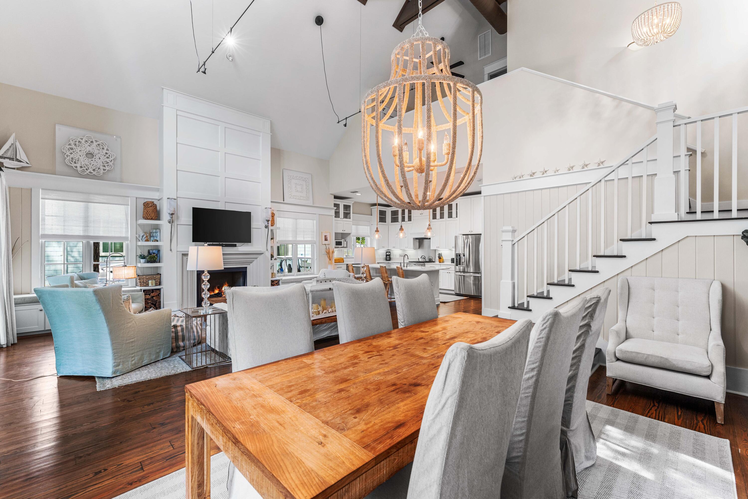 406 Red Cedar Way Santa Rosa Beach, FL 32459 - Photo 32 of 60 a dining room with wooden floor a chandelier a wooden table and chairs