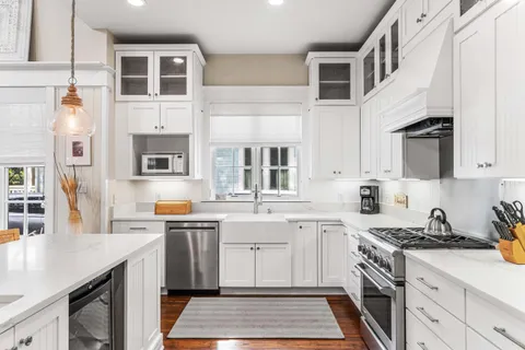 a bathroom with a granite countertop sink mirror vanity and toilet