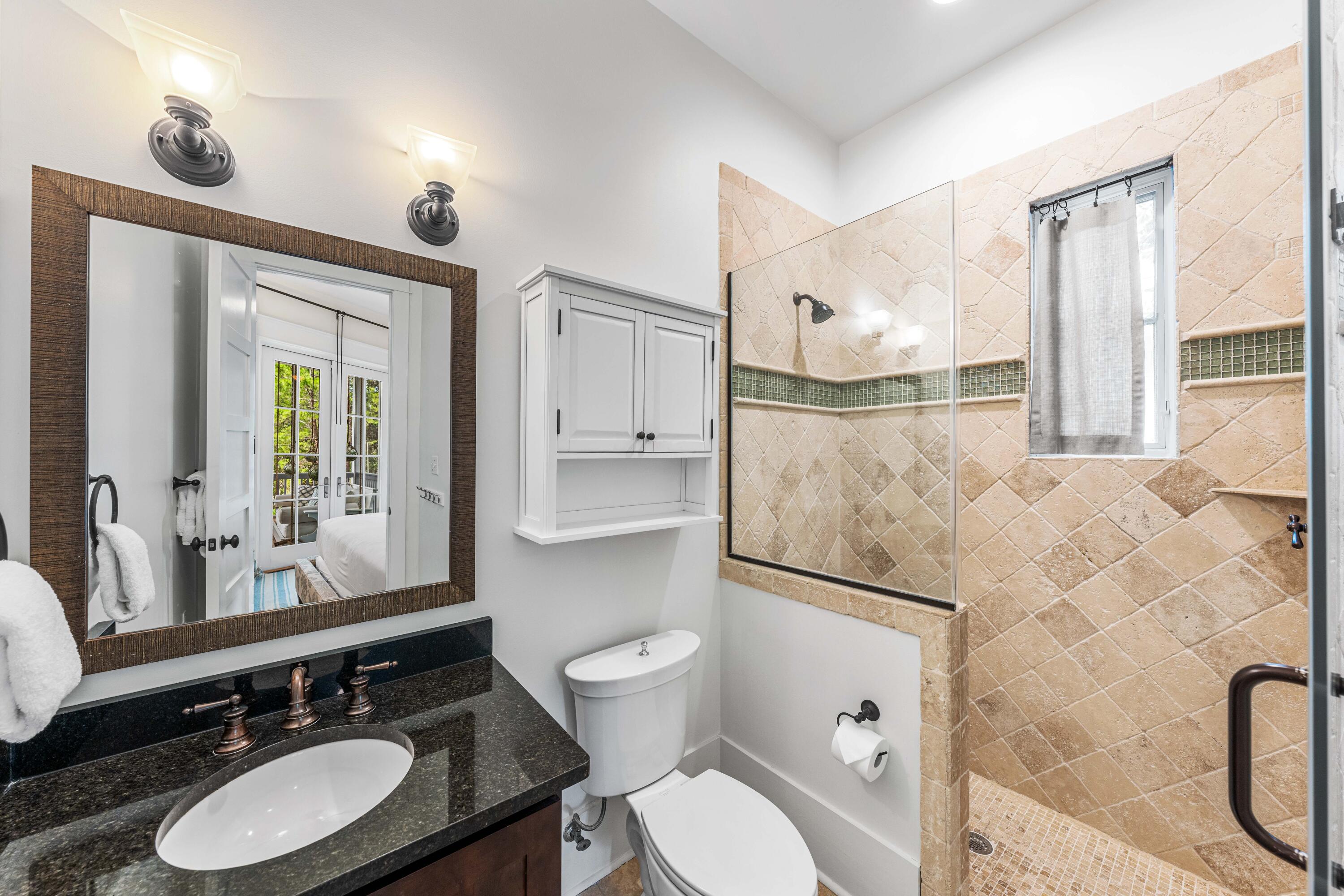 406 Red Cedar Way Santa Rosa Beach, FL 32459 - Photo 45 of 60 a bathroom with a granite countertop sink mirror vanity and toilet