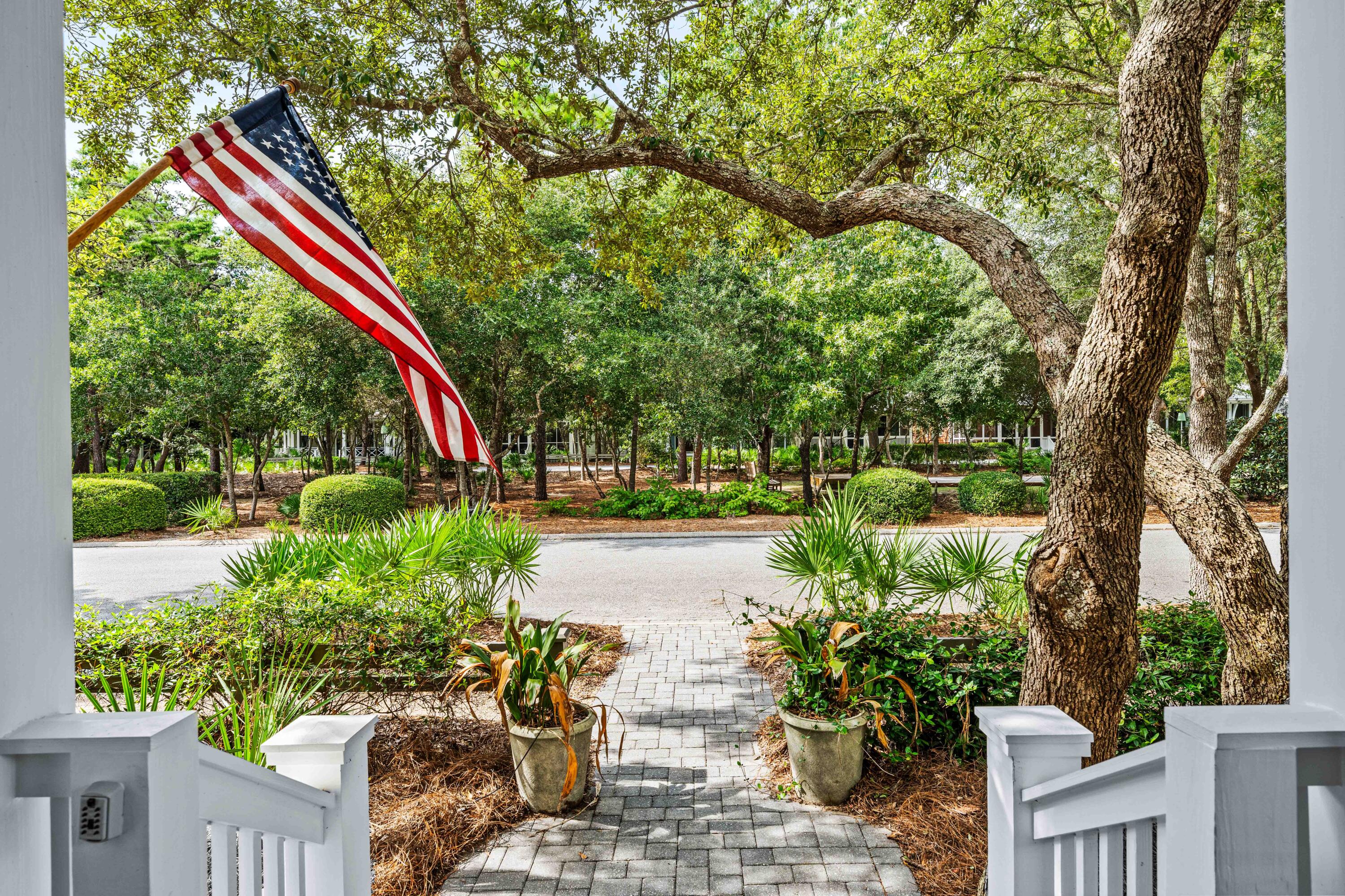 406 Red Cedar Way Santa Rosa Beach, FL 32459 - Photo 5 of 60 a view of a park with plants and a bench