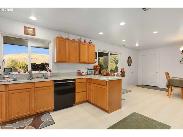 a kitchen with stainless steel appliances granite countertop a sink and a stove