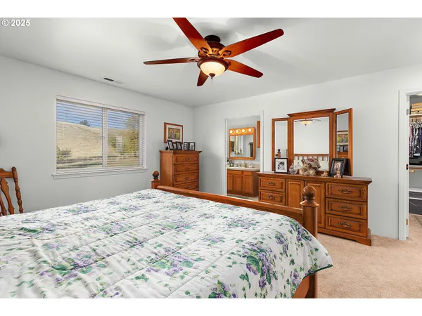 a bedroom with a large bed and a dresser