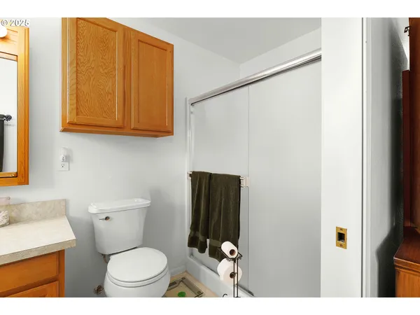 a bathroom with a toilet a sink and a shower curtain