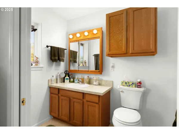 a bathroom with a toilet sink and mirror