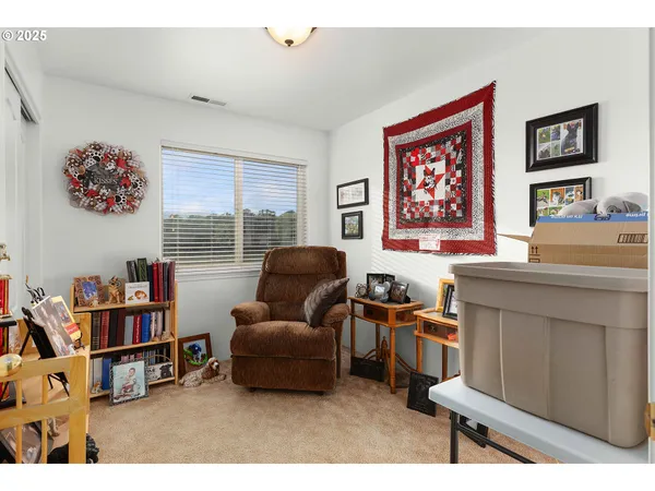 a living room with furniture and a bookshelf