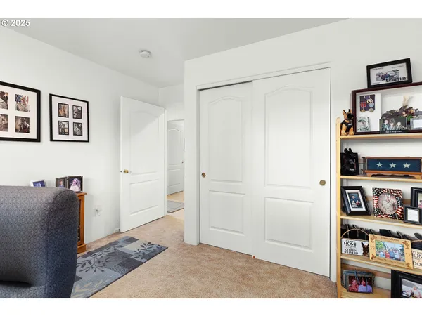 a living room with furniture and a book shelf