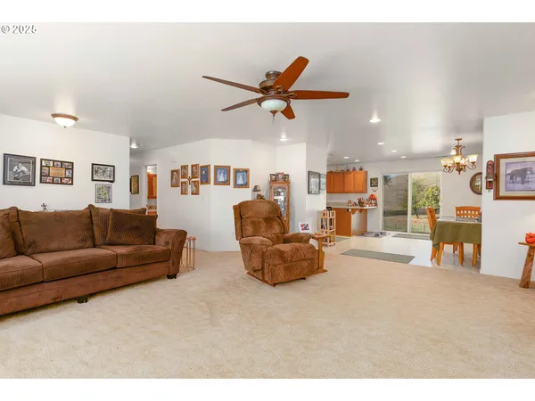 a living room with furniture and kitchen view