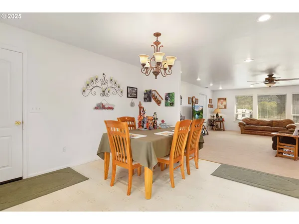 a dining room with furniture a chandelier and wooden floor