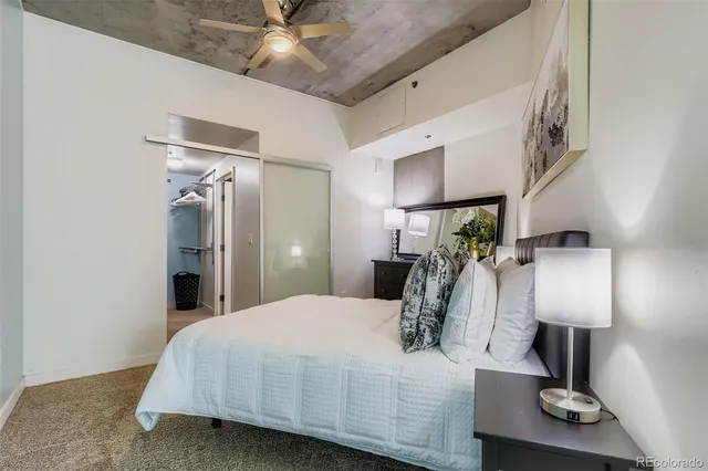 a bed room with a bed and a lamp