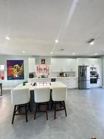 a kitchen with cabinets and stainless steel appliances