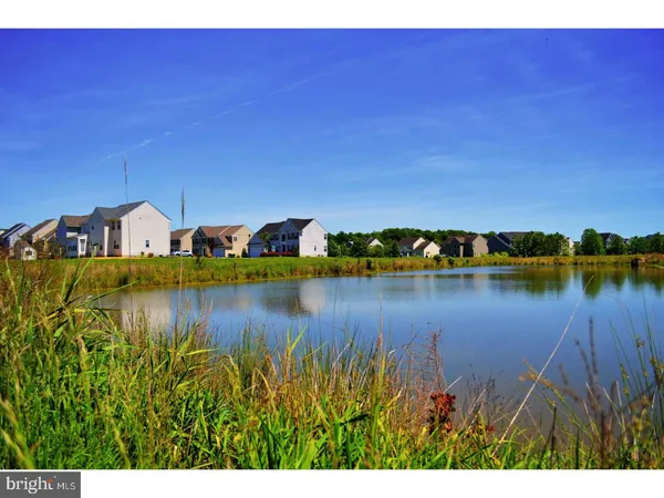a view of a lake with a house in the background
