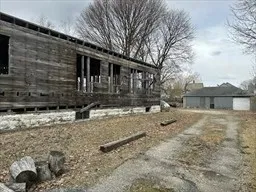 a backyard of a house with barbeque oven