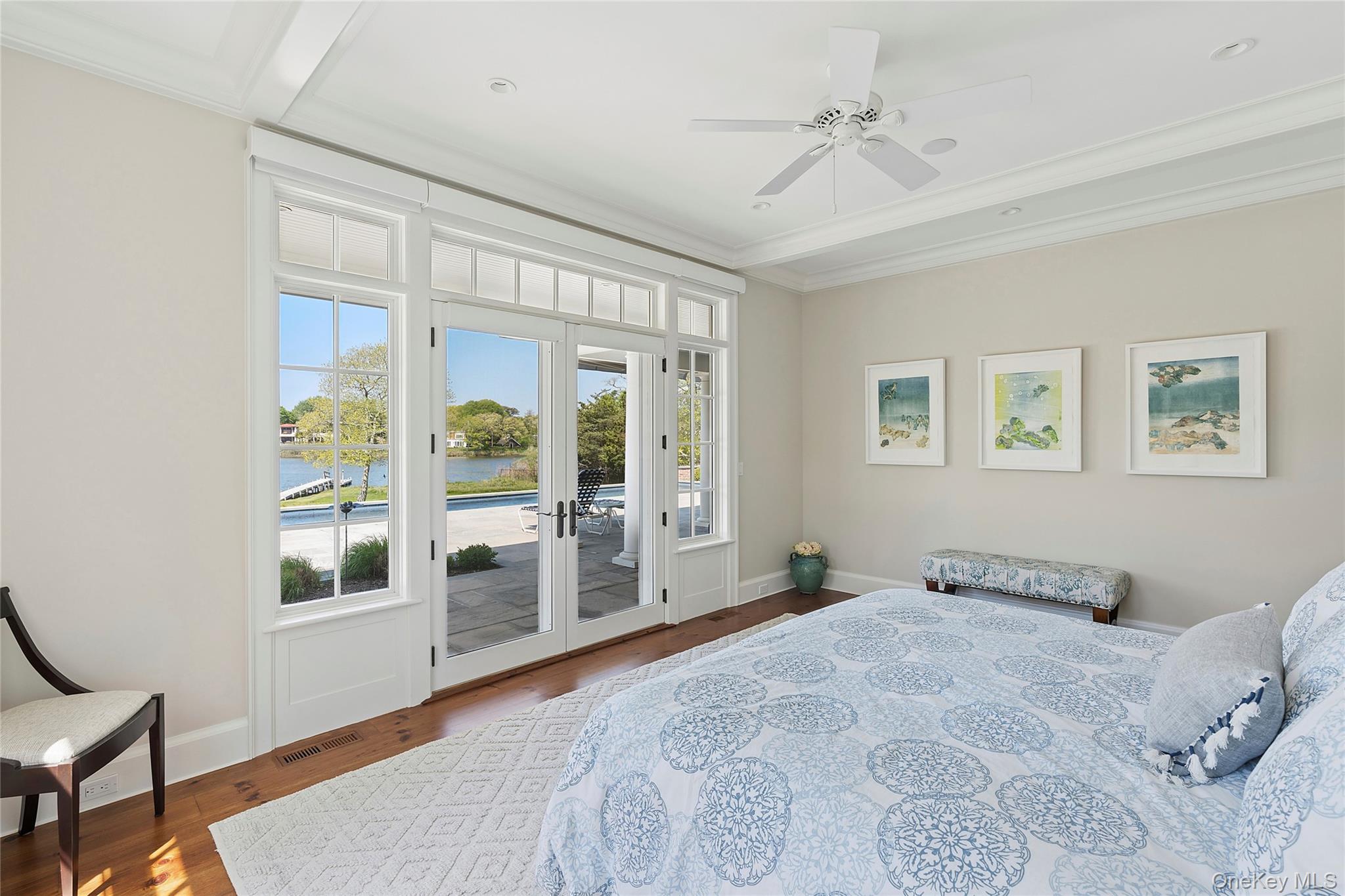 43 Old Main Road Quogue, NY 11959 - Photo 13 of 28 a bedroom with a large bed and a window