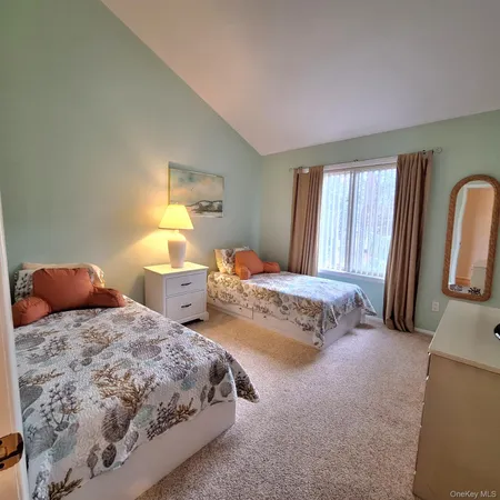 a bedroom with two beds and painting on the wall