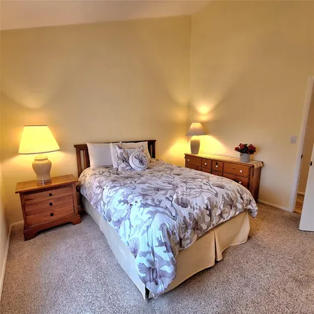 a bedroom with a bed and lamp with window