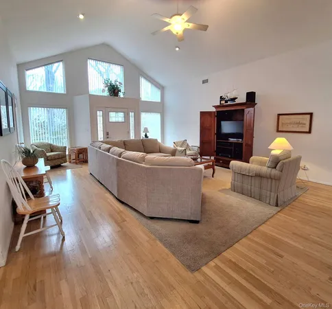 a living room with fireplace furniture and a wooden floor