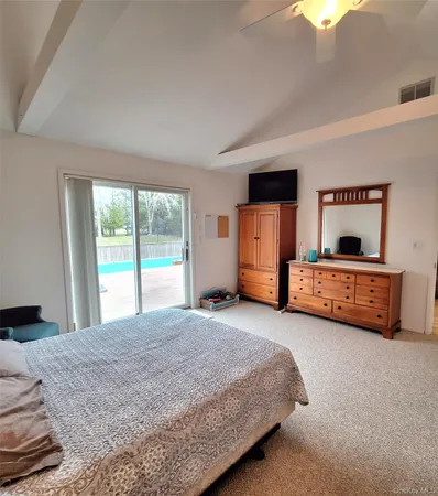 a spacious bedroom with a bed and a window