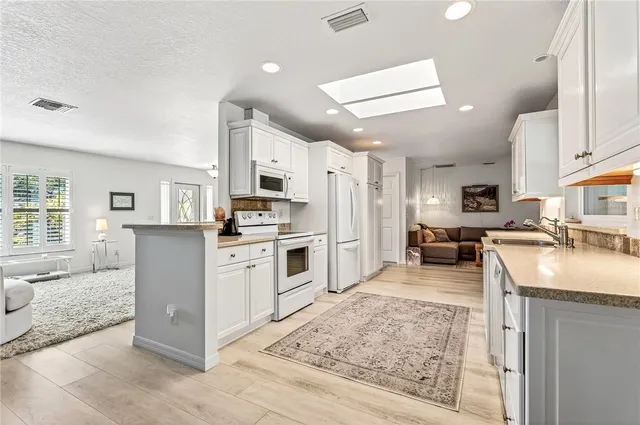 a kitchen with cabinets and wooden floor