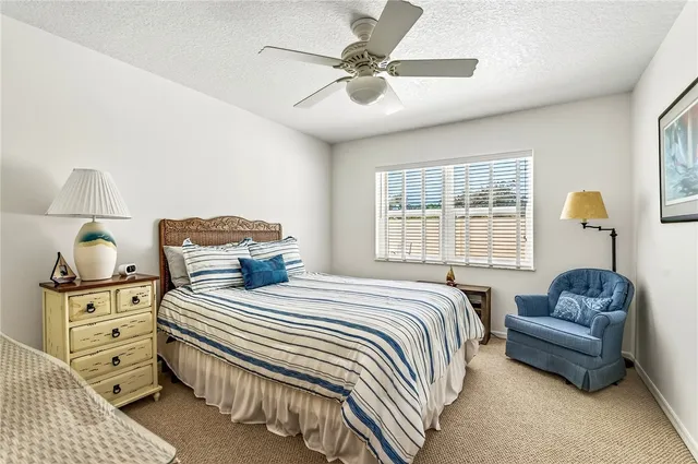 a bedroom with a bed and ceiling fan