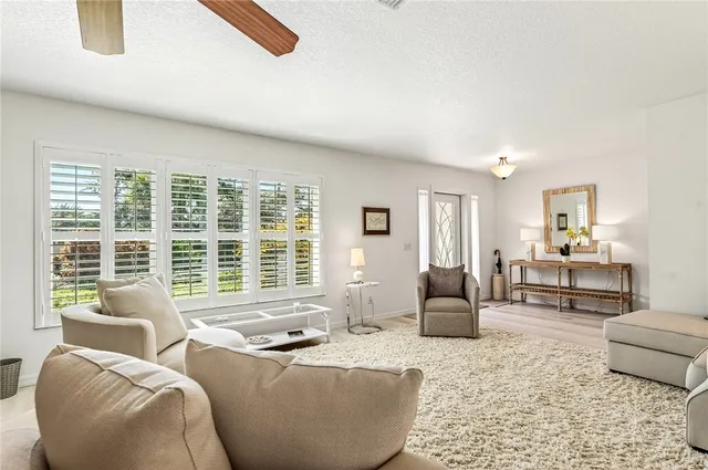 a living room with furniture and large windows