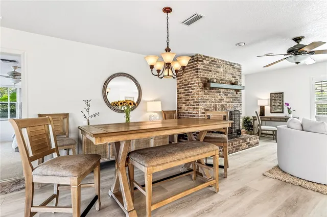 a living room with furniture a table and chair