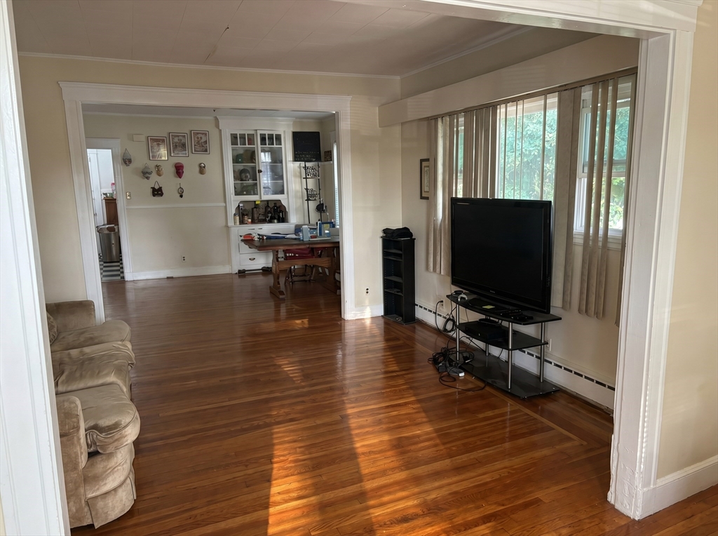 175 Coleman Street, Unit 2 Malden, MA 02148 - Photo 2 of 7 a living room with furniture and a flat screen tv