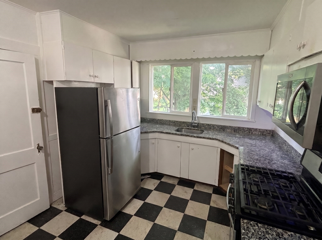175 Coleman Street, Unit 2 Malden, MA 02148 - Photo 4 of 7 a kitchen with a refrigerator a sink and a stove
