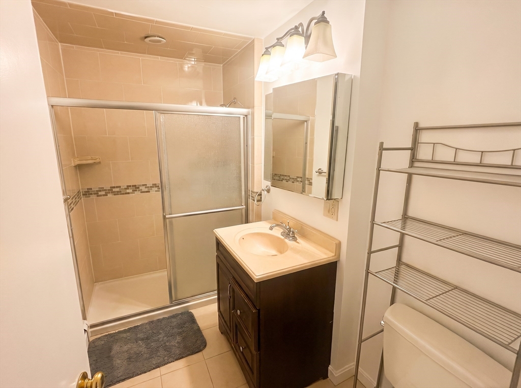 175 Coleman Street, Unit 2 Malden, MA 02148 - Photo 5 of 7 a bathroom with a sink a mirror and shower