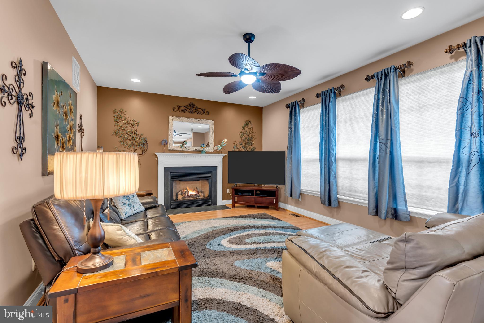 3 Pheasant Court, Unit 2710 Columbus, NJ 08022 - Photo 15 of 39 a living room with furniture a fireplace and a large window