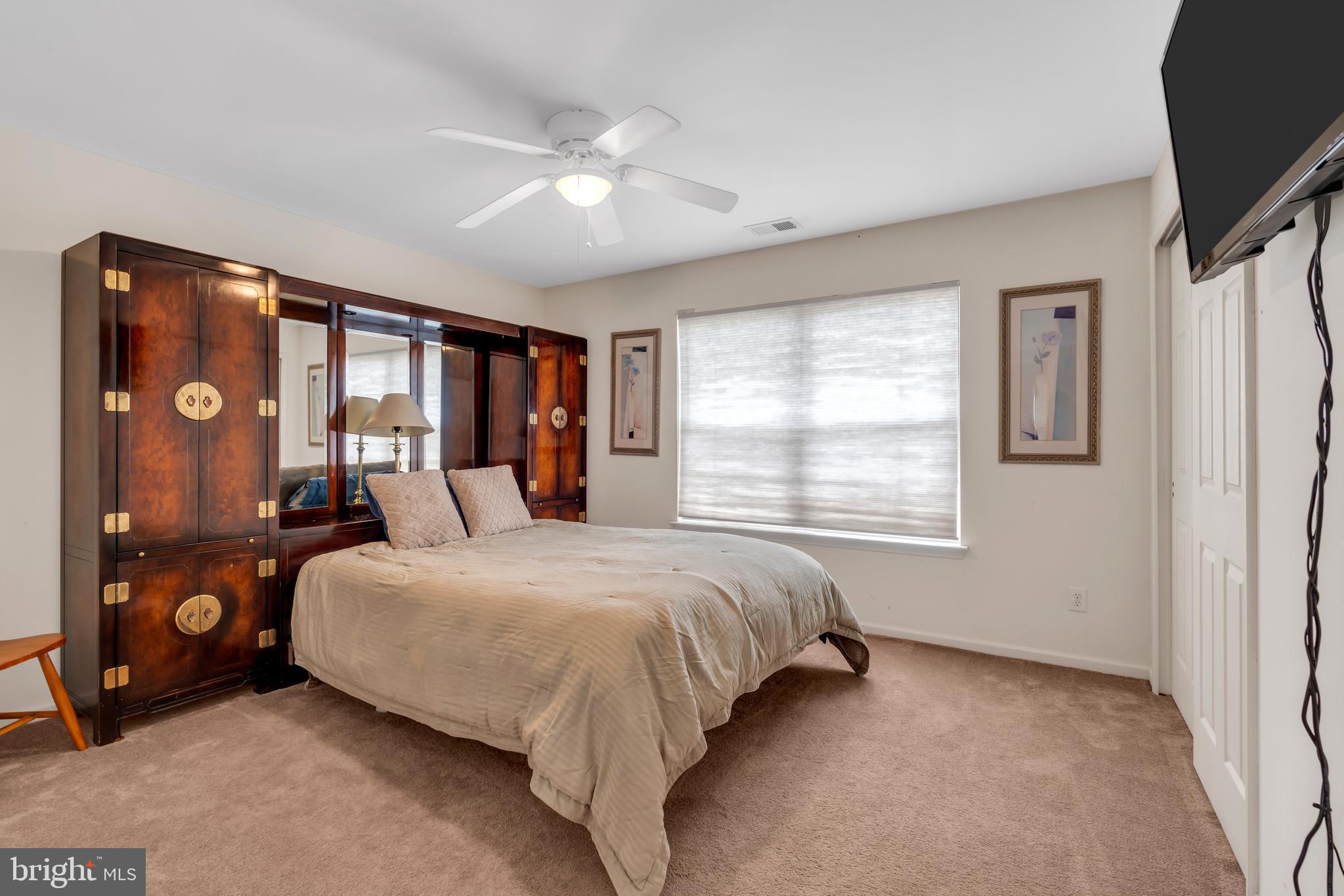 3 Pheasant Court, Unit 2710 Columbus, NJ 08022 - Photo 26 of 39 a bedroom with a large bed and a window
