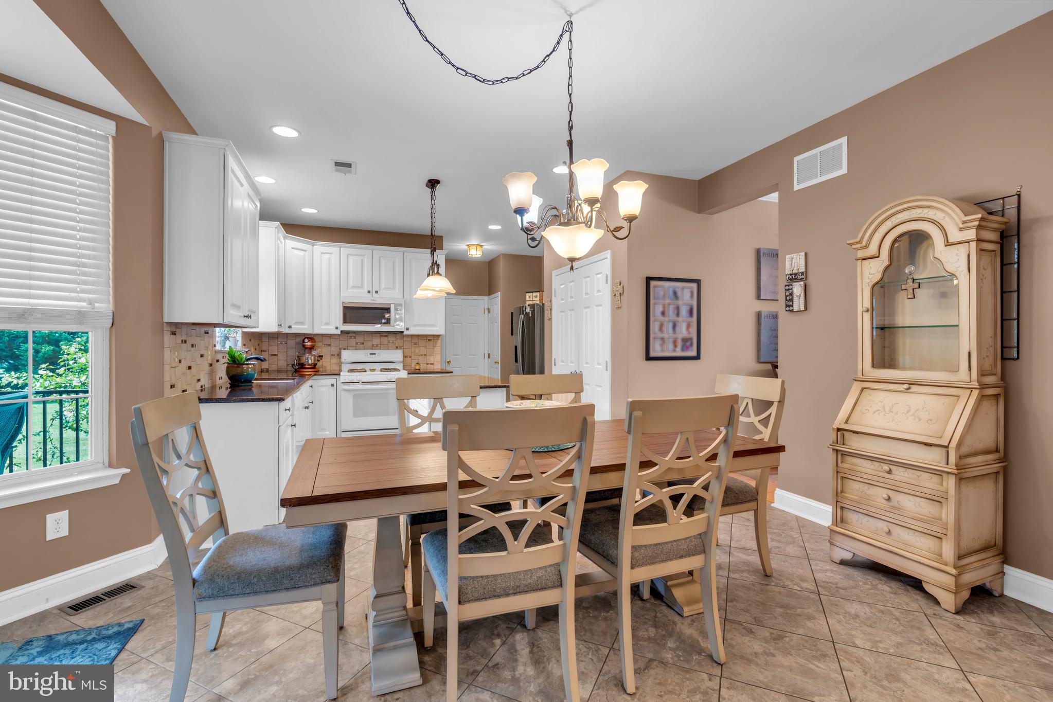 3 Pheasant Court, Unit 2710 Columbus, NJ 08022 - Photo 8 of 39 a dining room with furniture a chandelier and window